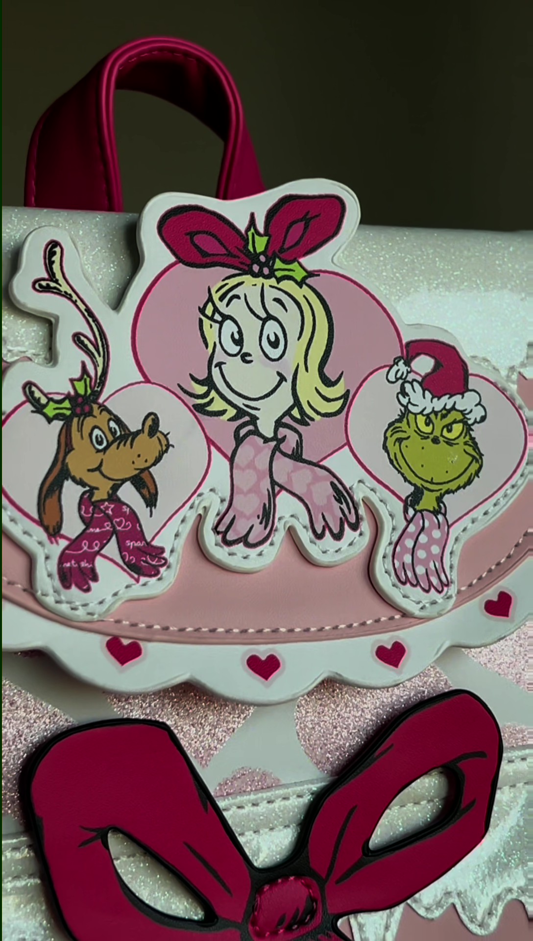 Bring some merry magic to your outfit with this exclusive Dr. Seuss Pink Cindy Lou Who Mini Backpack! Designed with playful accents and the signature Cindy Lou charm, this mini pack is ideal for fans who love a pop of pastel holiday fun.